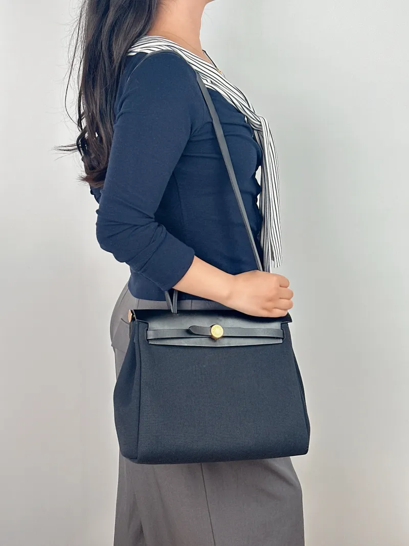 Hermès Crossbody Bag Herbag 31 Black Canvas Medium 30.5 × 11 × 25.5 cm Y — on-model view 1 of 2