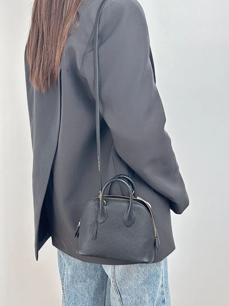 Hermès Crossbody Bag Bolide 1923 Top Handle Bag Black Lambskin Mini 18 × 8 × 15 cm K — on-model view 2 of 2