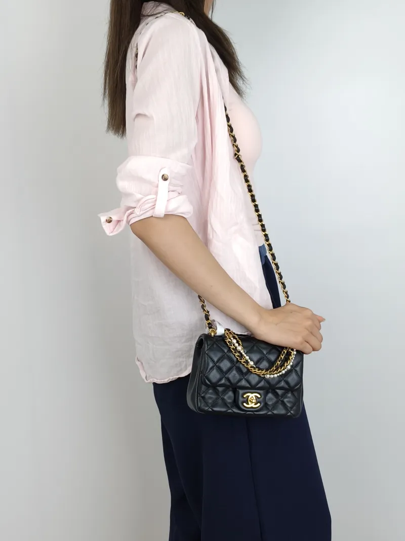 Chanel Crossbody Bag24p Pearl Black Lambskinmini17 × 5 × 12.5 cm — on-model view 2 of 3