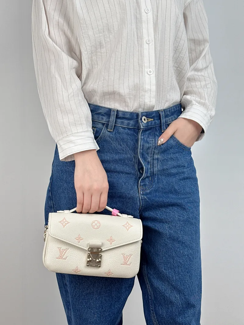 Louis Vuitton Crossbody Bag Pochette Métis East West White · Pink Monogram Empreinte Embossed Calfskin Small 21.5 × 6 × 13.5 cm — on-model view 1 of 3