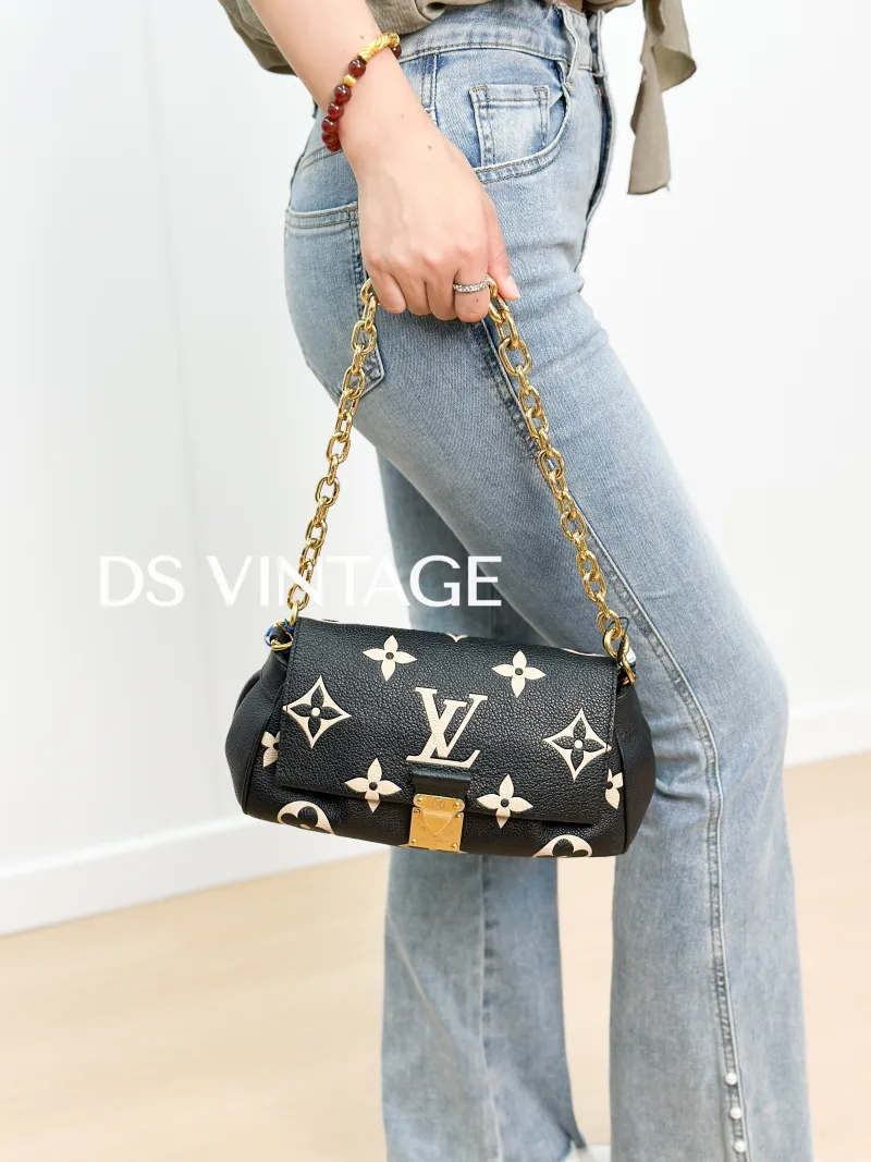 Louis Vuitton Crossbody Bag Favorite Black · White Empreinte Embossed Calfskin Medium 24 × 9 × 14 cm — on-model view 3 of 3