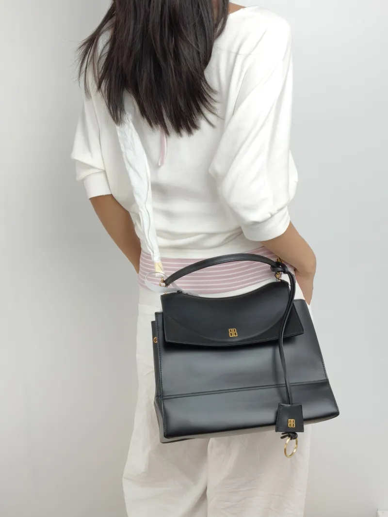 BALENCIAGA Crossbody Bag Top Handle Crossbody Bag Black Calfskin One Size 28 × 12 × 23 cm — on-model view 1 of 2
