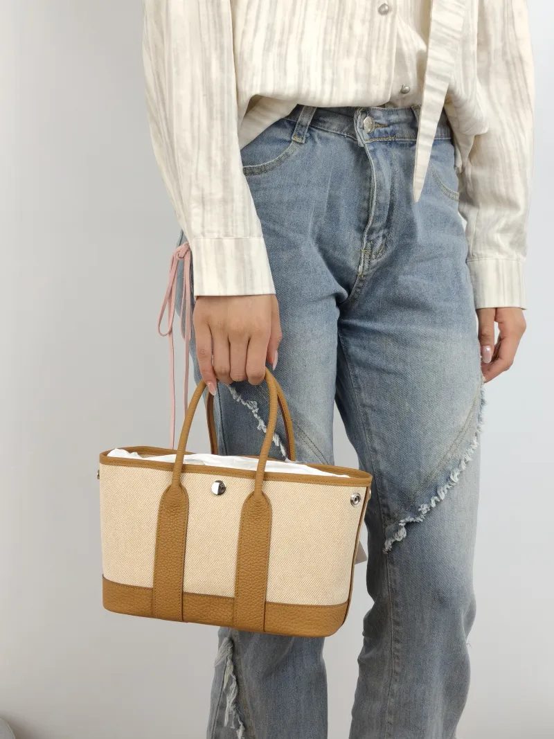 Hermès Top Handle Bag Neo Garden 23 Mini Canvas · Negonda Calfskin Mini 23 × 10 × 16 cm G — on-model view 2 of 2