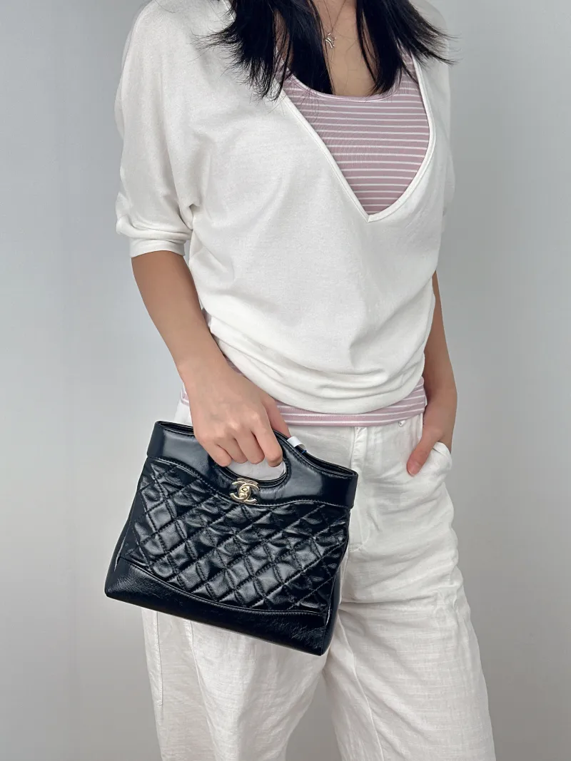Chanel Crossbody Bag31Bag Black Waxed Leathermini23 × 5.5 × 22 cm — on-model view 2 of 3