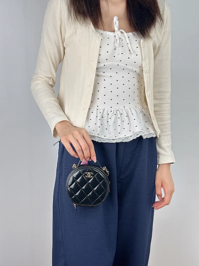 Chanel Crossbody Bag Crossbody Bag Black with Gold-Tone Hardware Waxed Leather Mini 12 × 5.5 × 11 cm — on-model view 1 of 2