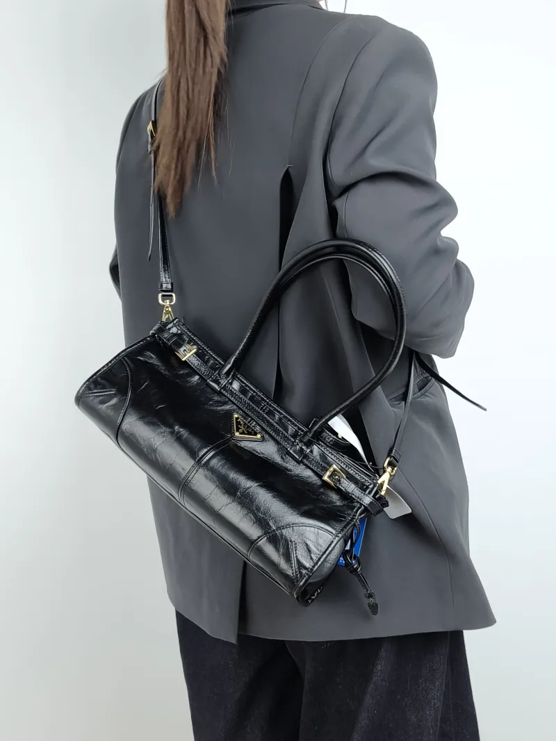PRADA Shoulder Bag Bonnie Soft Lux Black Waxed Leather Medium 32 × 12 × 15.5 cm — on-model view 3 of 4