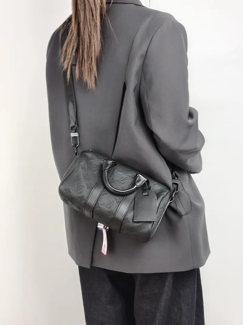 Louis Vuitton Crossbody Bag Keepall 25 Taurillon Monogram Embossed Calfskin Medium 25 × 11 × 15 cm — on-model view 3 of 3