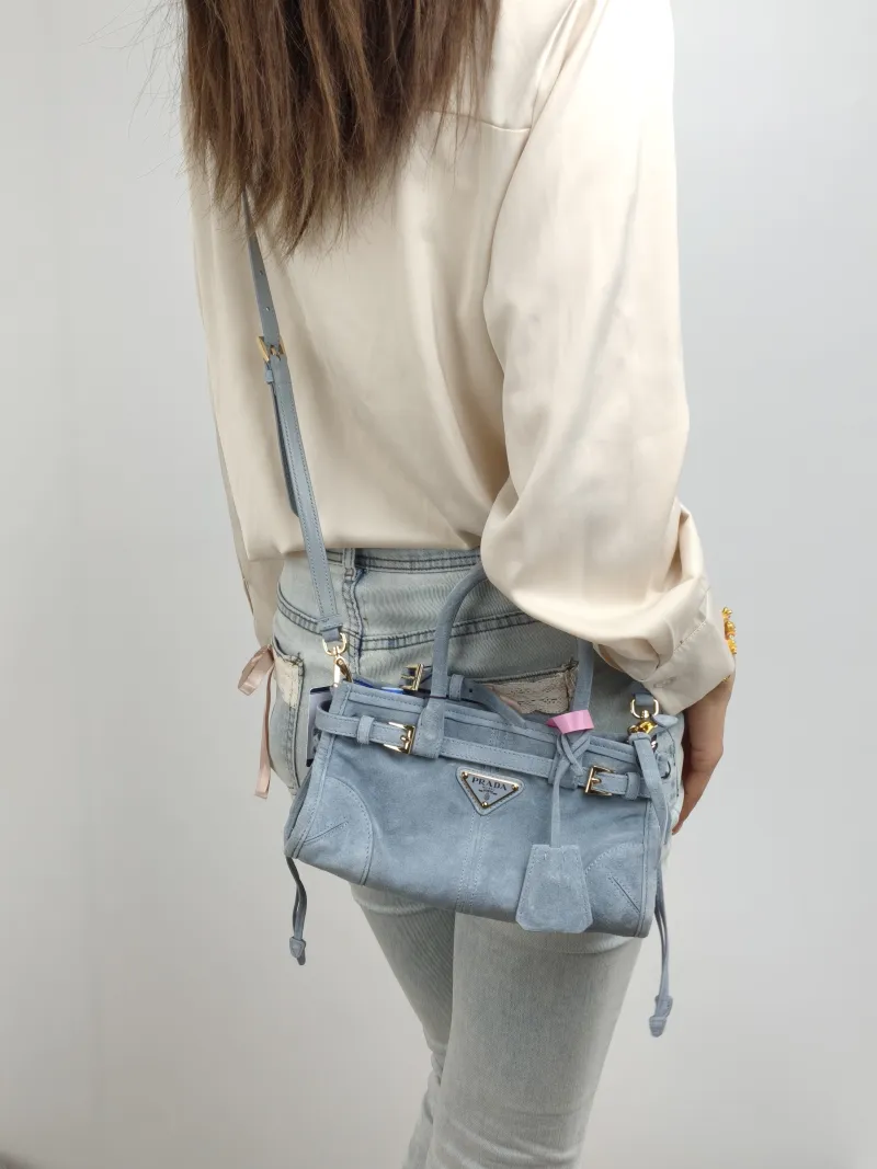 PRADA Top Handle Bag Bonnie Soft Lux Blue Suede Mini 23.5 × 9 × 12 cm — on-model view 2 of 2