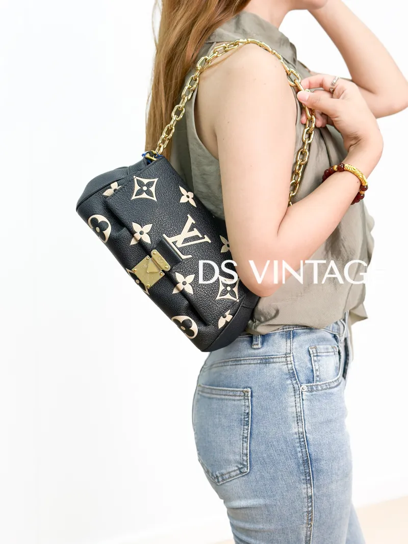Louis Vuitton Crossbody Bag Favorite Black · White Empreinte Embossed Calfskin Medium 24 × 9 × 14 cm — on-model view 2 of 3