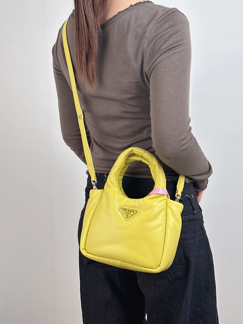 PRADA Top Handle Bag Soft Yellow Lambskin Small 18 × 10 × 15.5 cm — on-model view 1 of 2