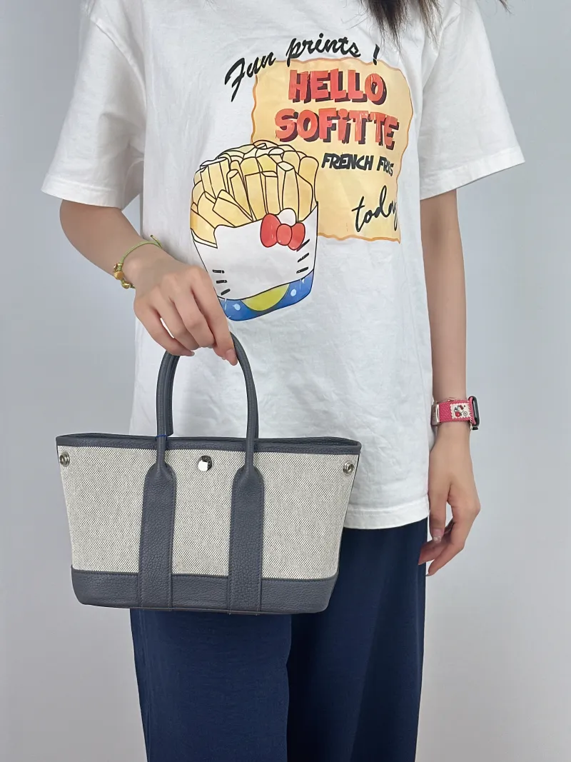 Hermès Top Handle Bag Neo Garden 23 Mini Beige · Canvas · Negonda Calfskinmini23 × 10 × 16 cm — on-model view 2 of 2