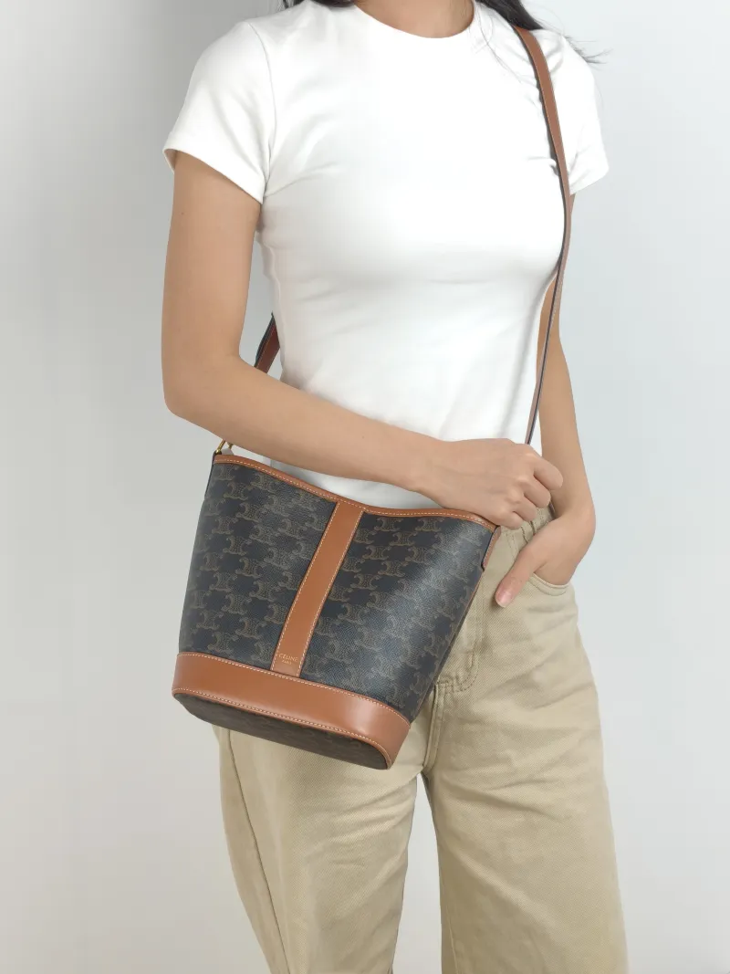 CELINE Crossbody Bag Triomphe Bucket Bag Monogram PVC Small 22 × 13 × 26 cm — on-model view 1 of 2