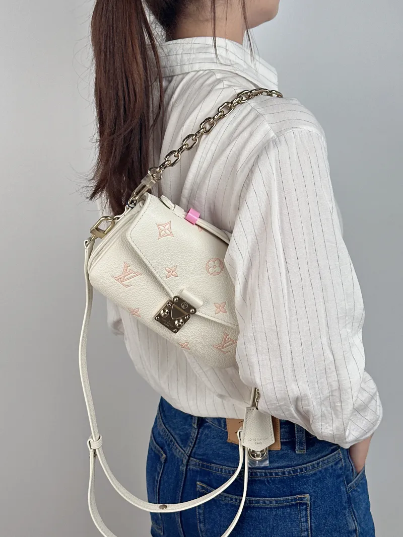 Louis Vuitton Crossbody Bag Pochette Métis East West White · Pink Monogram Empreinte Embossed Calfskin Small 21.5 × 6 × 13.5 cm — on-model view 2 of 3