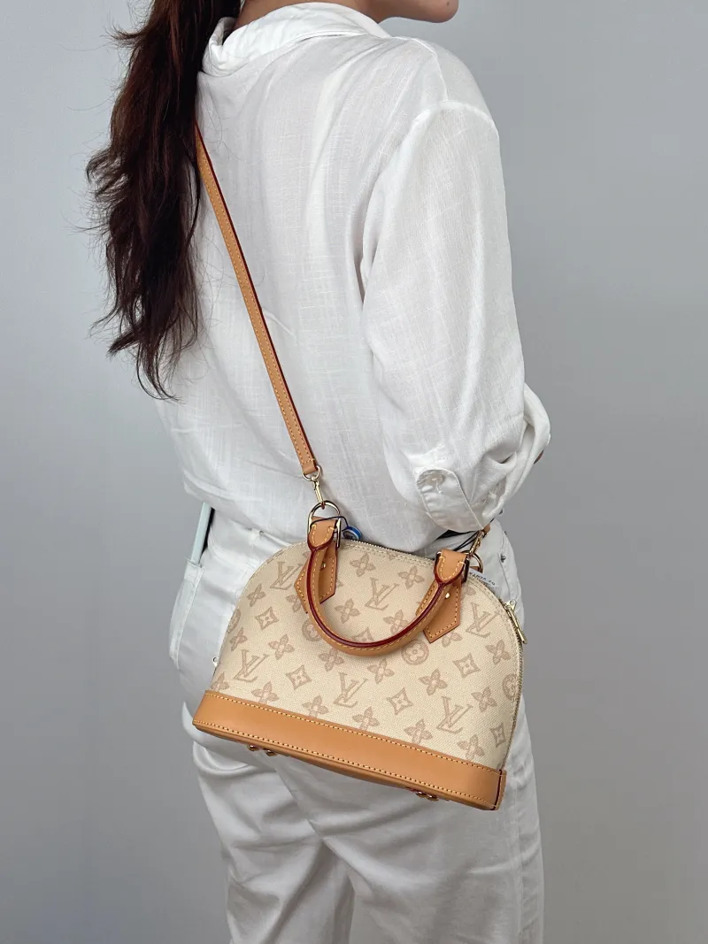 Louis Vuitton Top Handle Bag Alma BB PVCBB23.5 × 11.5 × 17.5 cm — on-model view 2 of 2