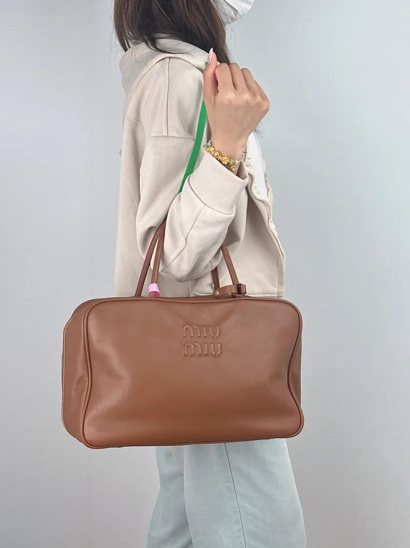Miumiu Top Handle Bag Beau CC alfskin Large 34 × 10 × 23 cm — on-model view 1 of 2