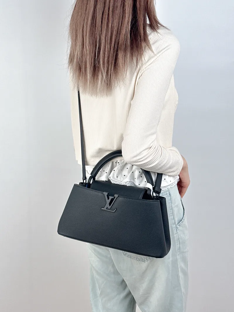 Louis Vuitton Top Handle Bag Capucines East West Black Calfskin Medium33 × 9 × 19 cm — on-model view 2 of 3