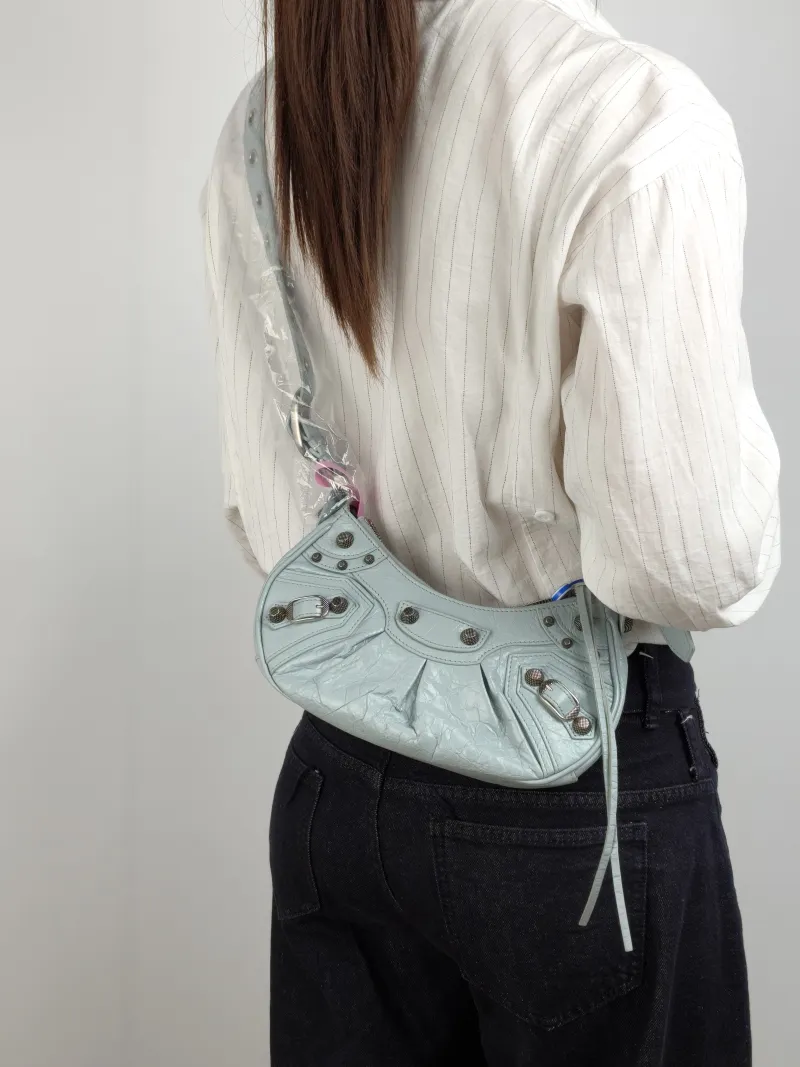 BALENCIAGA Crossbody Bag LE CAGOLE Lambskin XS 26 × 7 × 16 cm — on-model view 1 of 2