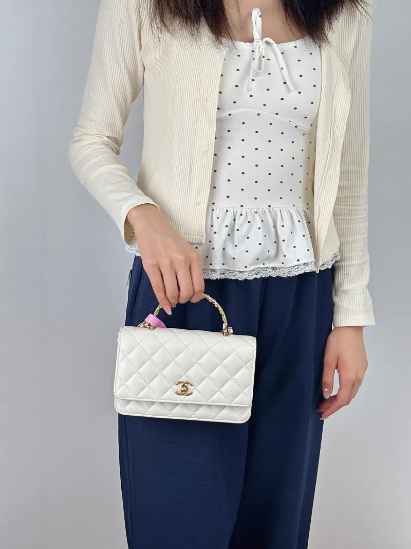 Chanel Crossbody Bag woc White Gold Grained Calfskin Mini 19.2 × 3.5 × 12.3 cm — on-model view 1 of 2