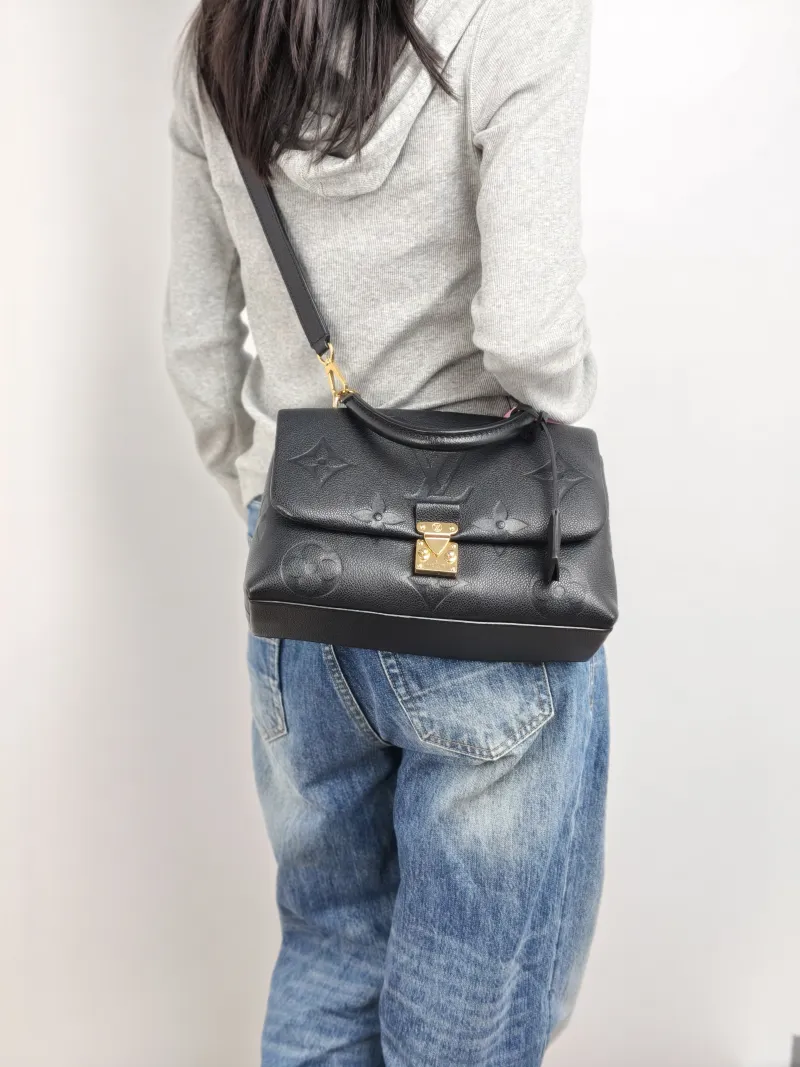 Louis Vuitton Crossbody Bag MADELEINE Black Monogram Empreinte Embossed Calfskin Medium 30 × 11 × 19.5 cm — on-model view 1 of 3
