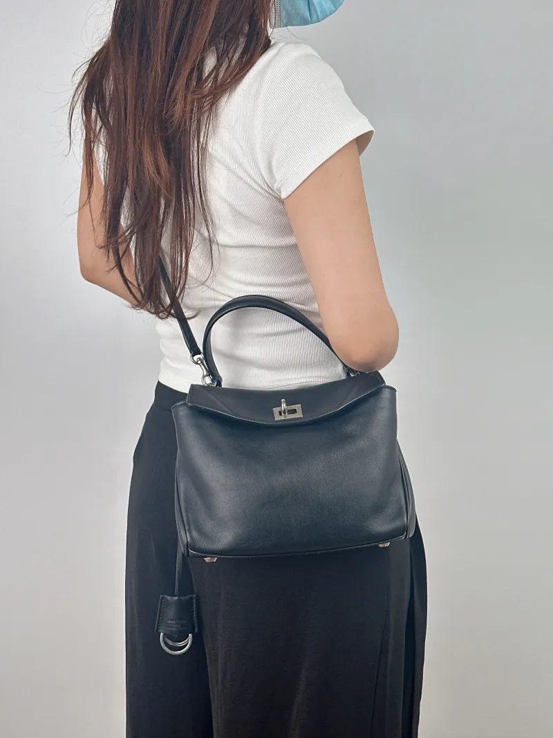 BALENCIAGA Crossbody Bag RODEO Black Calfskin Mini 23 × 10 × 17 cm — on-model view 1 of 2