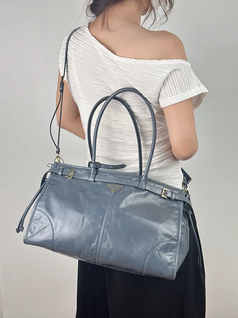 PRADA Shoulder Bag Bonnie Soft Lux Blue Waxed Leather Large 38 × 12 × 24 cm — on-model view 2 of 2
