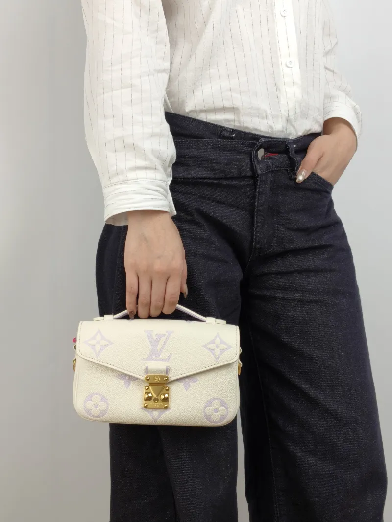 Louis Vuitton Crossbody Bag Pochette Métis East West White · Monogram Empreinte Embossed Calfskin Small 21.5 × 6 × 13.5 cm — on-model view 2 of 3