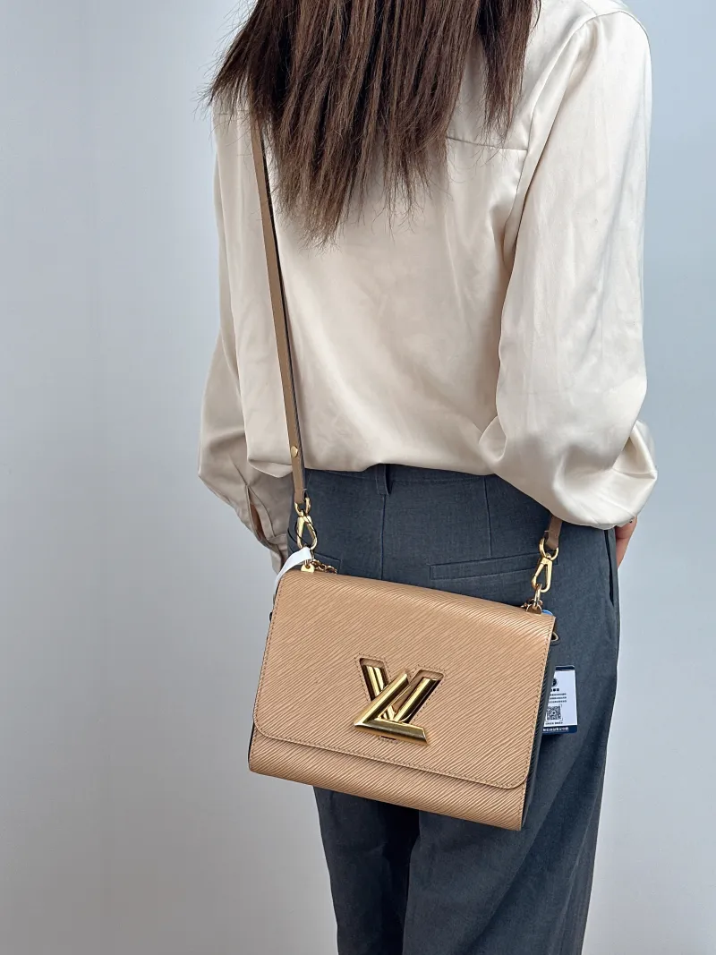 Louis Vuitton Crossbody Bag Twist Taupe Epi Embossed Calfskin Medium 23 × 9.5 × 17 cm — on-model view 1 of 2