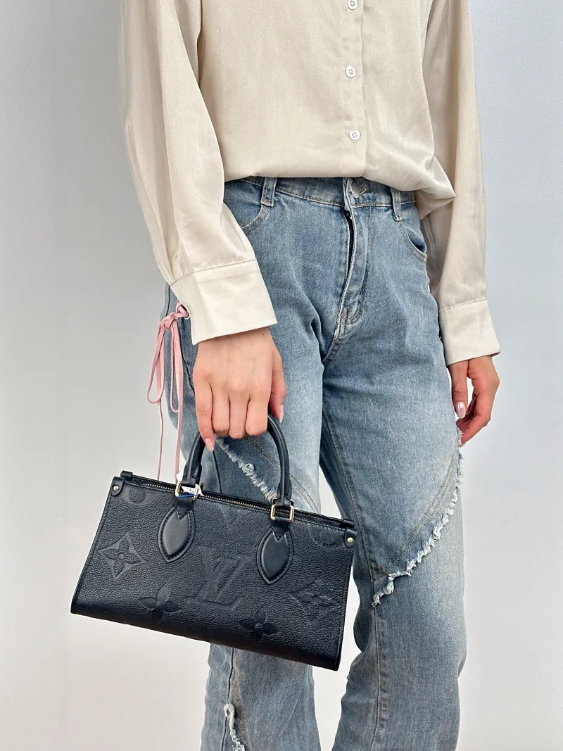 Louis Vuitton Crossbody Bag Onthego East West Two Straps Black Monogram Empreinte Embossed Calfskin Small 25 × 10 × 13 cm — on-model view 1 of 3