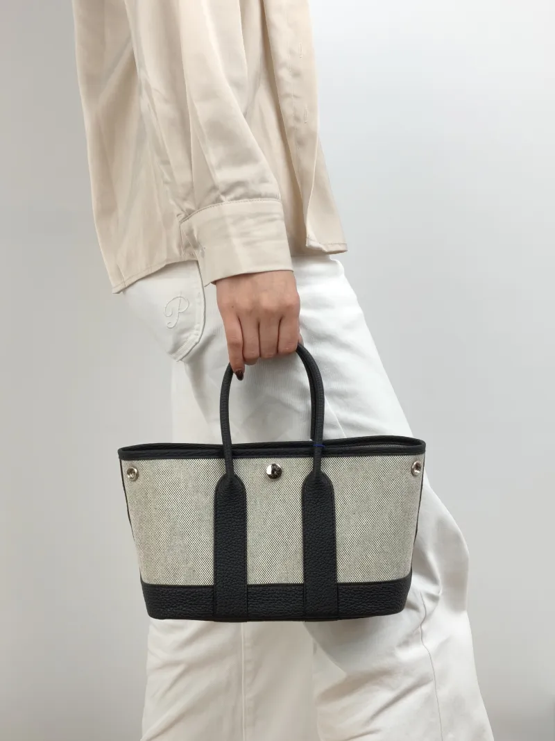 Hermès Top Handle Bag Neo Garden 23 Mini Black · Beige Canvas · Negonda Calfskin Mini 23 × 10 × 16 cm G — on-model view 1 of 2