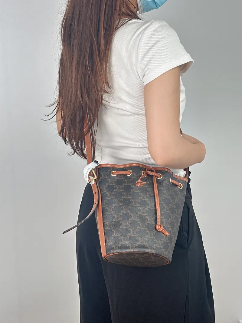 CELINE Crossbody Bag Triomphe Bucket Bag Monogram PVC Small 14 × 14 × 21 cm — on-model view 1 of 2