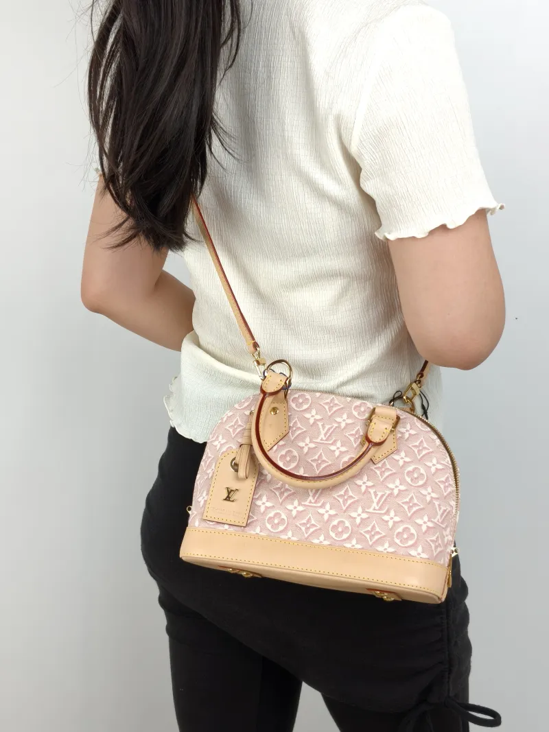 Louis Vuitton Top Handle Bag Alma BB Pink BB 23.5 × 11.5 × 17.5 cm — on-model view 1 of 3