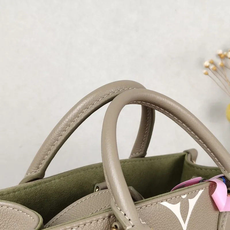 Louis Vuitton Top Handle Bag Onthego Monogram Empreinte Embossed Calfskin Small 25 × 11.5 × 19 cm — detail view 10 of 10