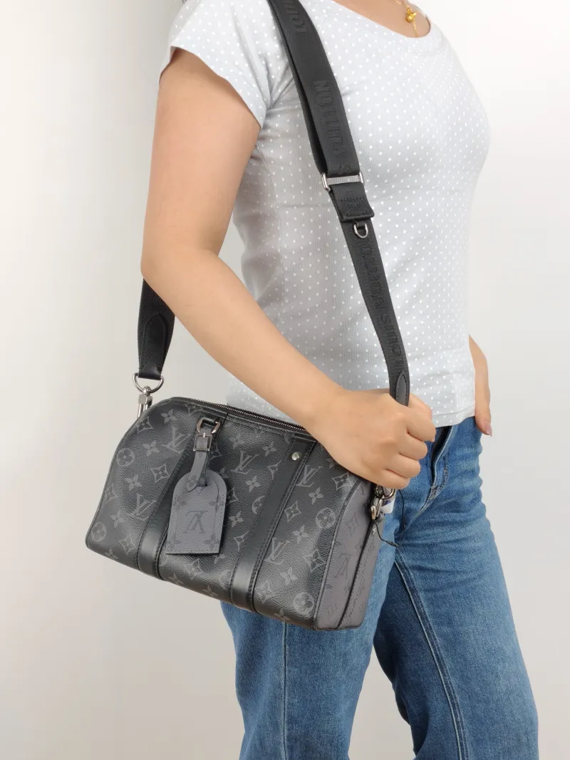 Louis Vuitton Crossbody Bag City Keepall Black PVC Medium 27 × 13 × 17 cm — on-model view 1 of 2