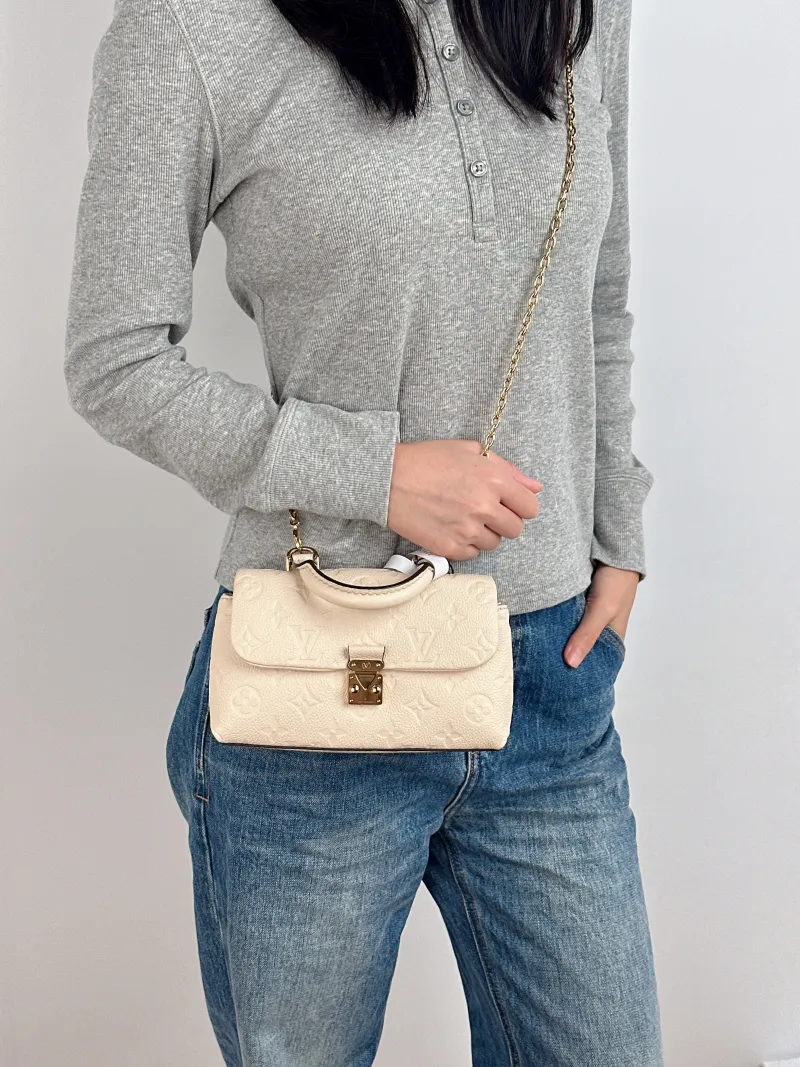 Louis Vuitton Crossbody Bag MADELEINE White Empreinte Embossed Calfskin nano 21 × 6 × 12.5 cm — on-model view 3 of 3