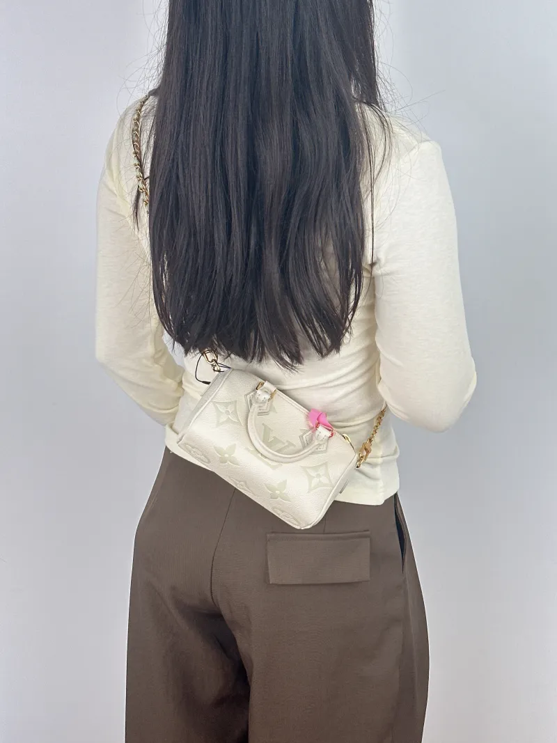 Louis Vuitton Crossbody Bag Speedy Nano White · Green Monogram Empreinte Embossed Calfskin nano 16 × 7.5 × 10 cm — on-model view 1 of 2