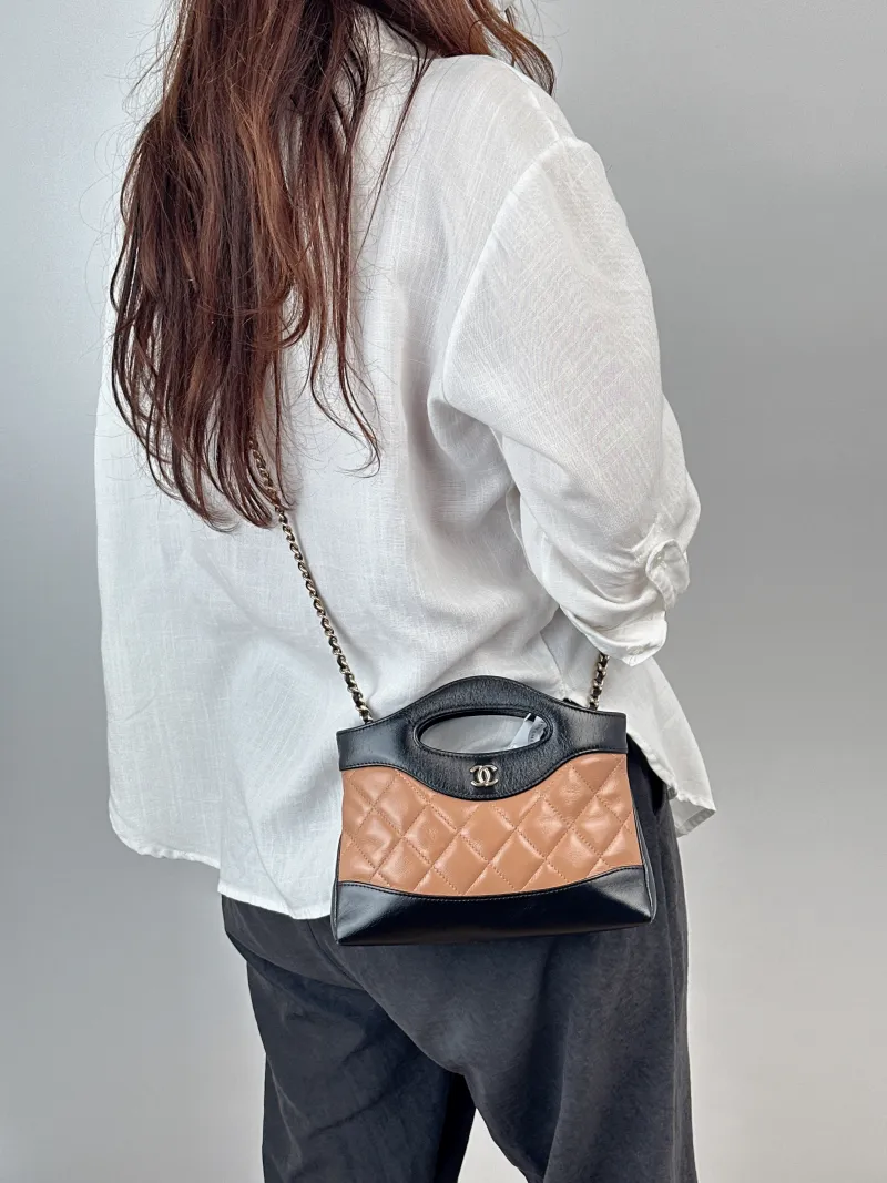 Chanel Crossbody Bag31Bag Beige · Black Waxed Leathernano19 × 5 × 12 cm — on-model view 1 of 2