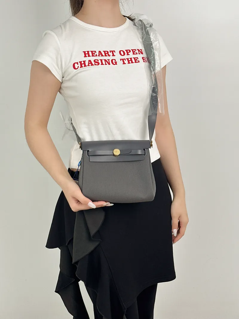 Hermès Crossbody Bag Herbag Zip 20 Calfskin，Canvasmini20.5 × 7 × 16.5 cm — on-model view 2 of 2