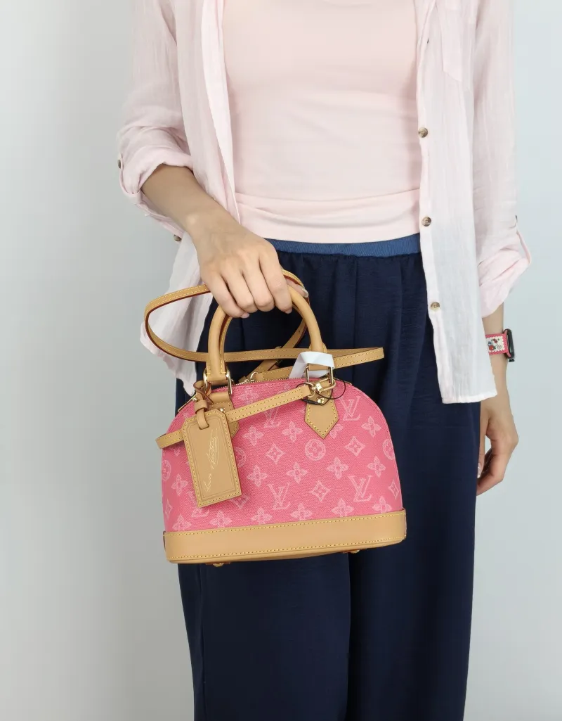 Louis Vuitton Top Handle Bag Alma BB Pink PVCBB23.5 × 11.5 × 17.5 cm — on-model view 1 of 3
