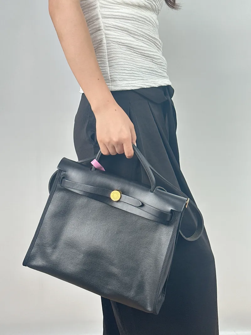 Hermès Crossbody Bag Herbag 31 Black Canvas Medium 30.5 × 11 × 25.5 cm W — on-model view 1 of 2