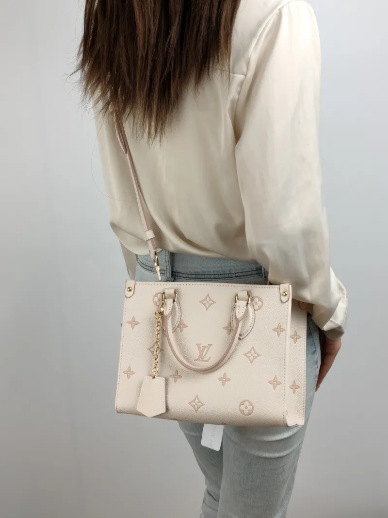 Louis Vuitton Shoulder Bag Onthego Beige · Pink Empreinte Embossed Calfskin Small 25 × 11.5 × 19 cm — on-model view 1 of 3