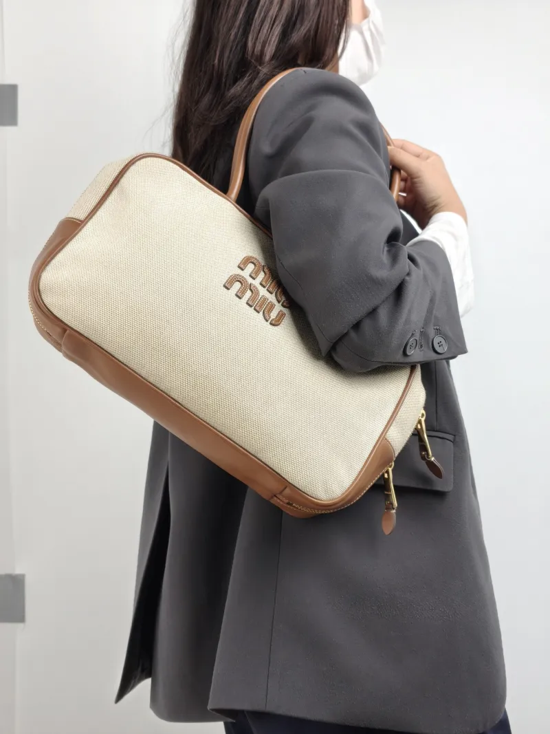 Miumiu Top Handle Bag Beau Brown Canvas · Calfskin Large 34 × 10 × 20 cm — on-model view 2 of 2