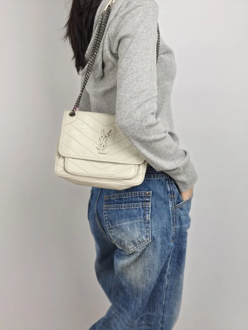 SAINT LAURENT Crossbody Bag Niki D Calfskin Small 21 × 7.5 × 16 cm — on-model view 1 of 2