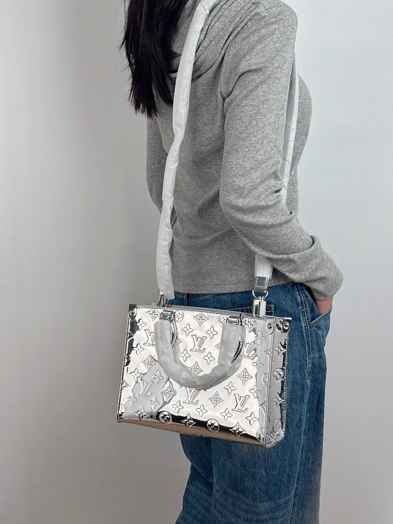 Louis Vuitton Top Handle Bag Onthego Silver Patent Leather Small 25 × 11.5 × 19 cm — on-model view 1 of 3