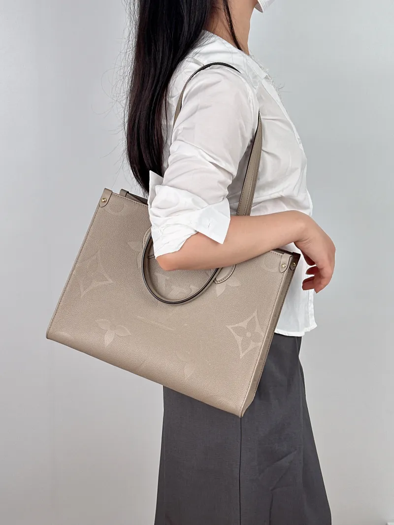 Louis Vuitton Shoulder Bag Onthego Medium Monogram Empreinte Embossed Calfskin Medium 35 × 14 × 27 cm — on-model view 1 of 2