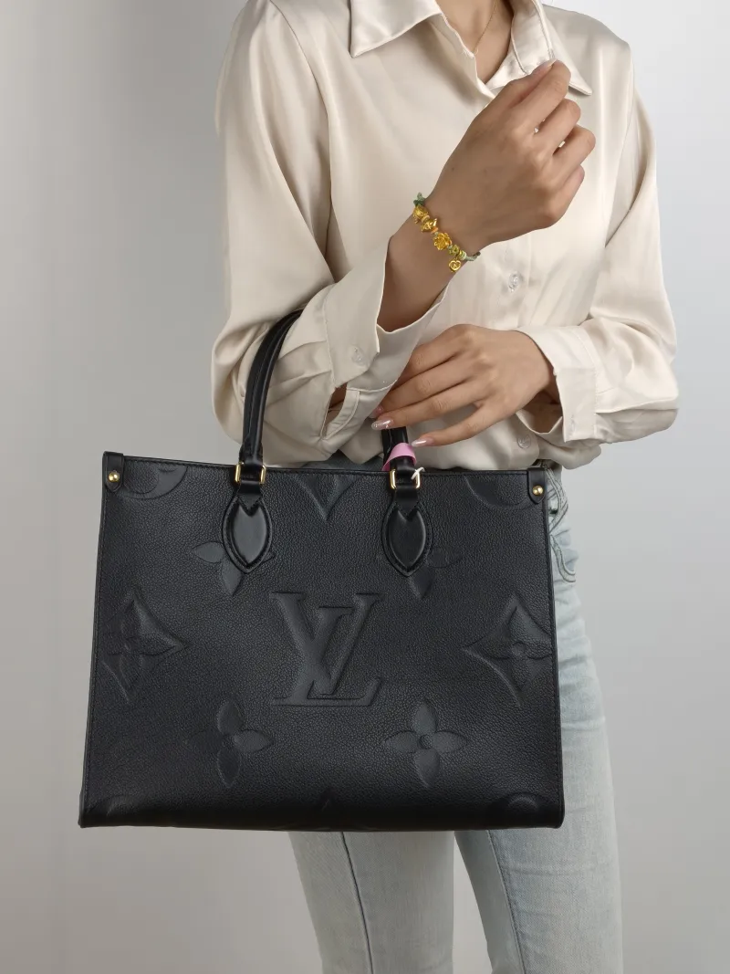 Louis Vuitton Shoulder Bag Onthego Medium Black Monogram Empreinte Embossed Calfskin Medium 35 × 14 × 27 cm — on-model view 1 of 2