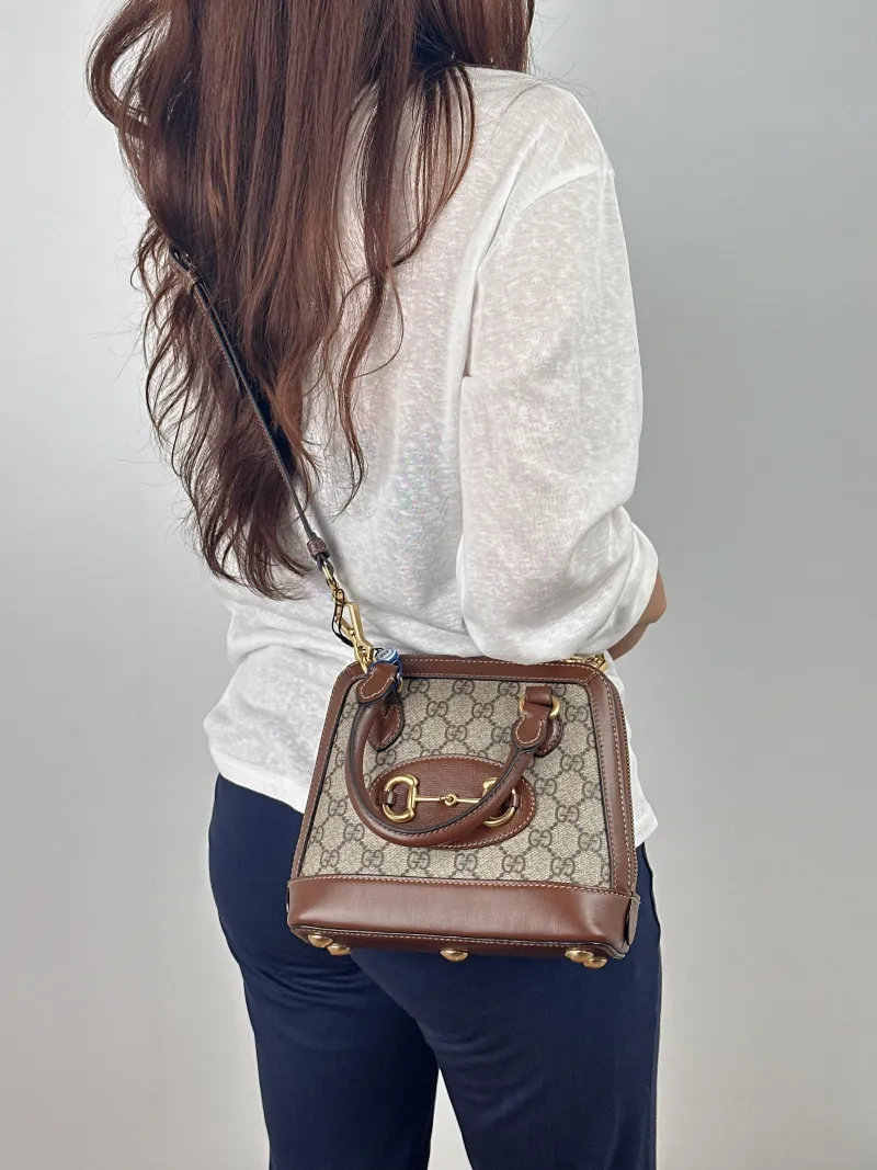 GUCCI Top Handle Bag Horsebit 1955 Horsebit Dome Bag Monogram PVC Mini 20 × 7.5 × 19.5 cm — on-model view 1 of 2