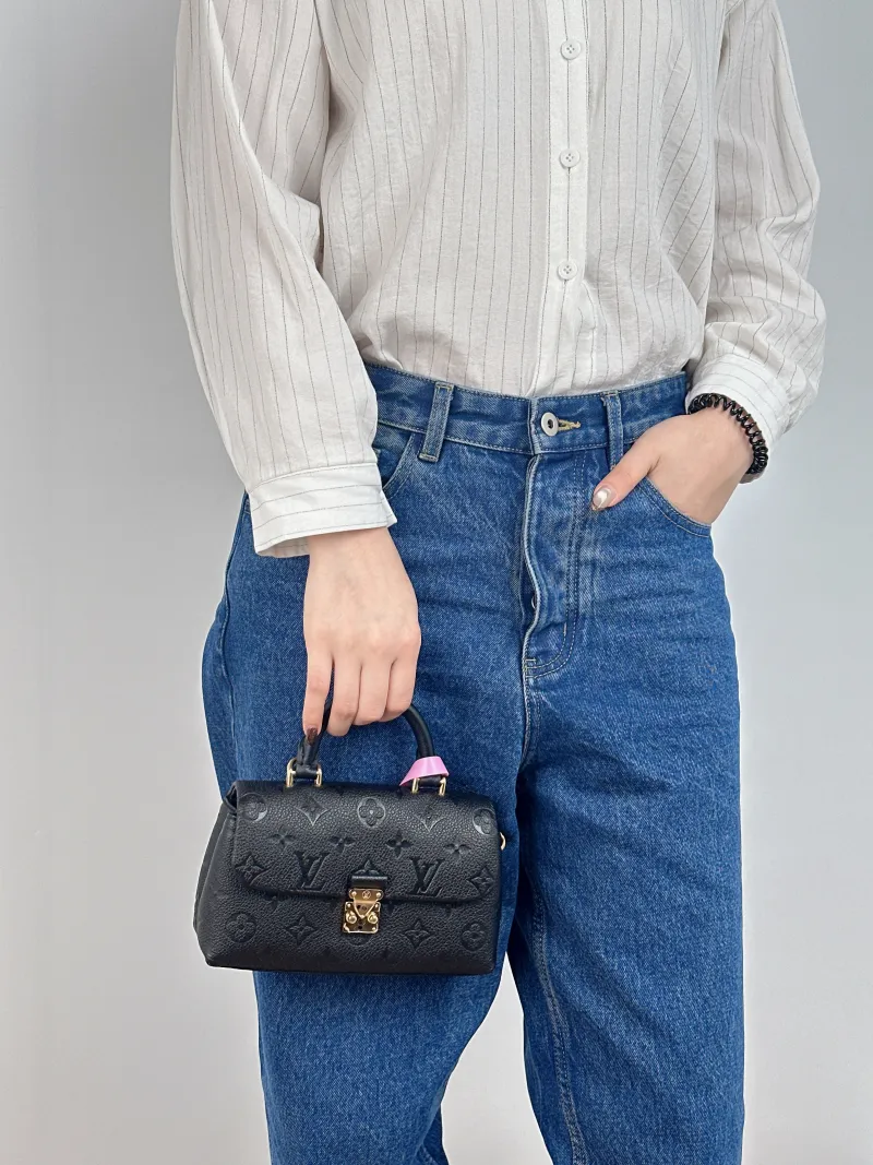 Louis Vuitton Crossbody Bag MADELEINE Black Monogram Empreinte Embossed Calfskin nano 21 × 6 × 12.5 cm — on-model view 2 of 2