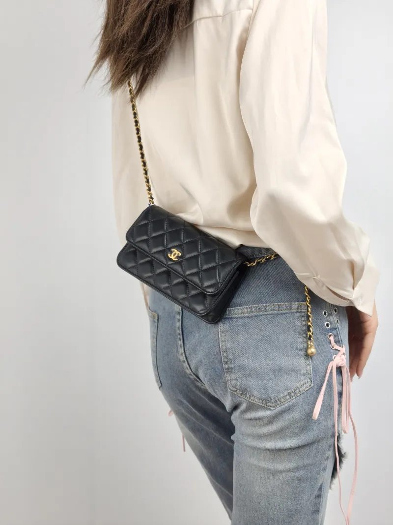 Chanel Crossbody Bag woc Black with Gold-Tone Hardware Lambskin Mini 17 × 5 × 9.5 cm — on-model view 1 of 2