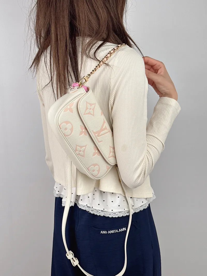 Louis Vuitton Crossbody Bag IVY White · Pink Empreinte Embossed Calfskin Small 23.5 × 4.3 × 12 cm — on-model view 1 of 2