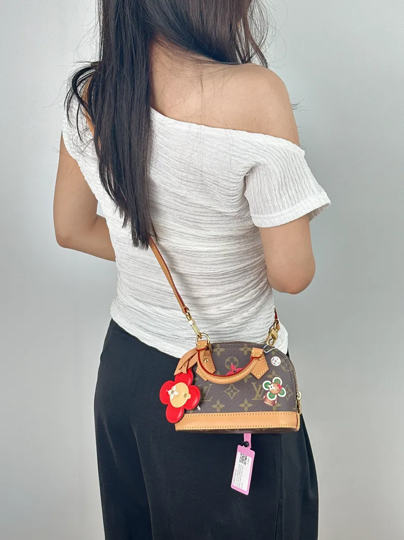 Louis Vuitton Crossbody Bag Alma Nano vivenne Monogram PVC nano 18 × 8 × 12 cm — on-model view 1 of 2